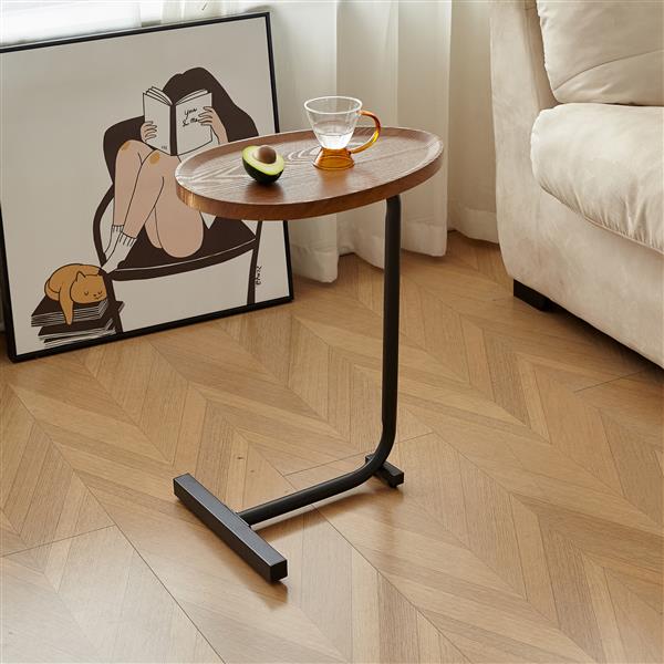 C-shaped side table next to an armchair