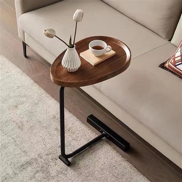 C-shaped side table base sliding under a couch