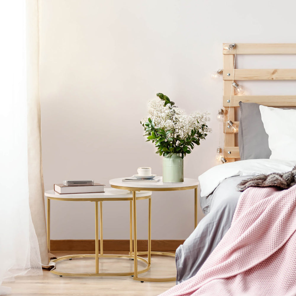 Nesting tables beside a bed