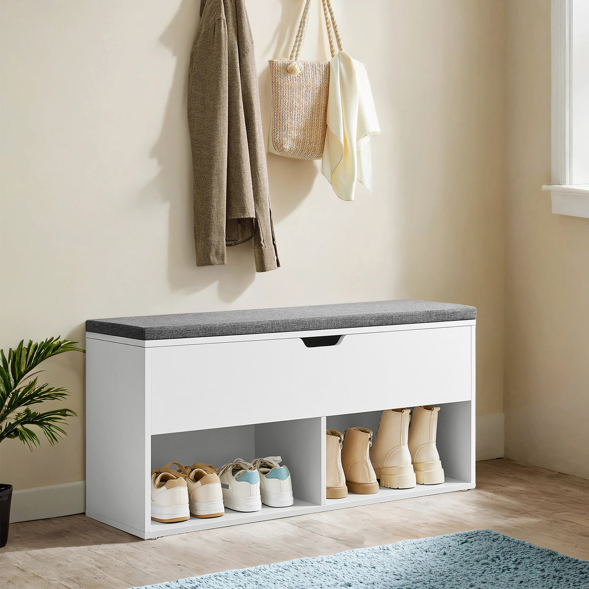Shoe storage bench holding shoes and boots