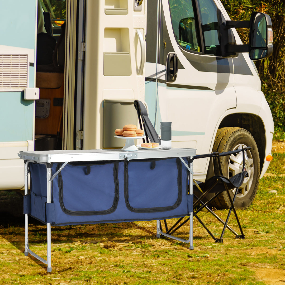 Folding camping table set up next to an RV