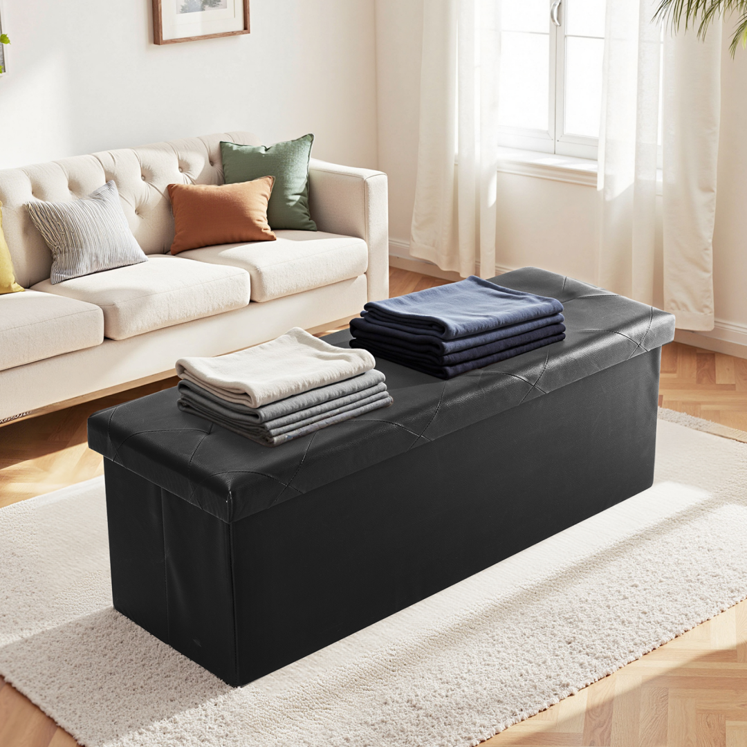 Black folding storage ottoman bench in a living room