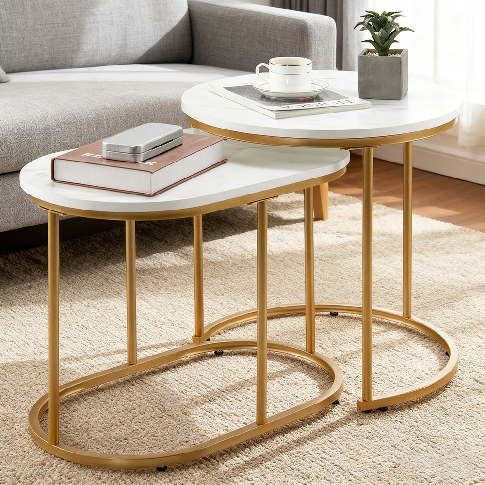 Marble-look nesting coffee tables with gold frames in a living room