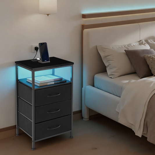 Black nightstand with LED lights beside a bed