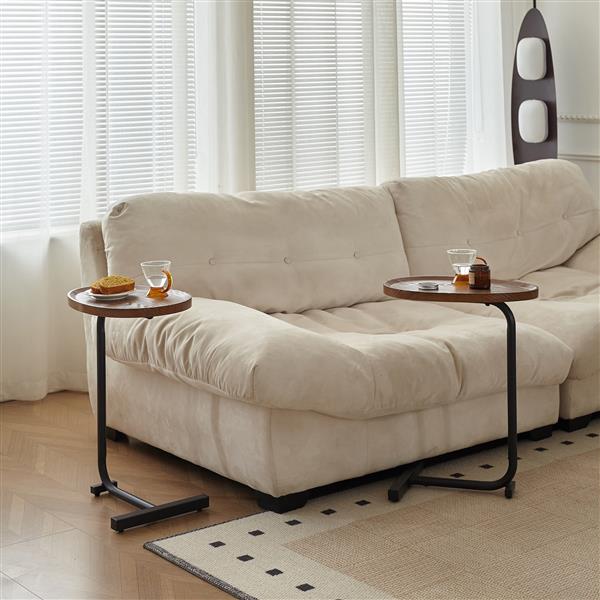 Two C-shaped side tables beside a sofa